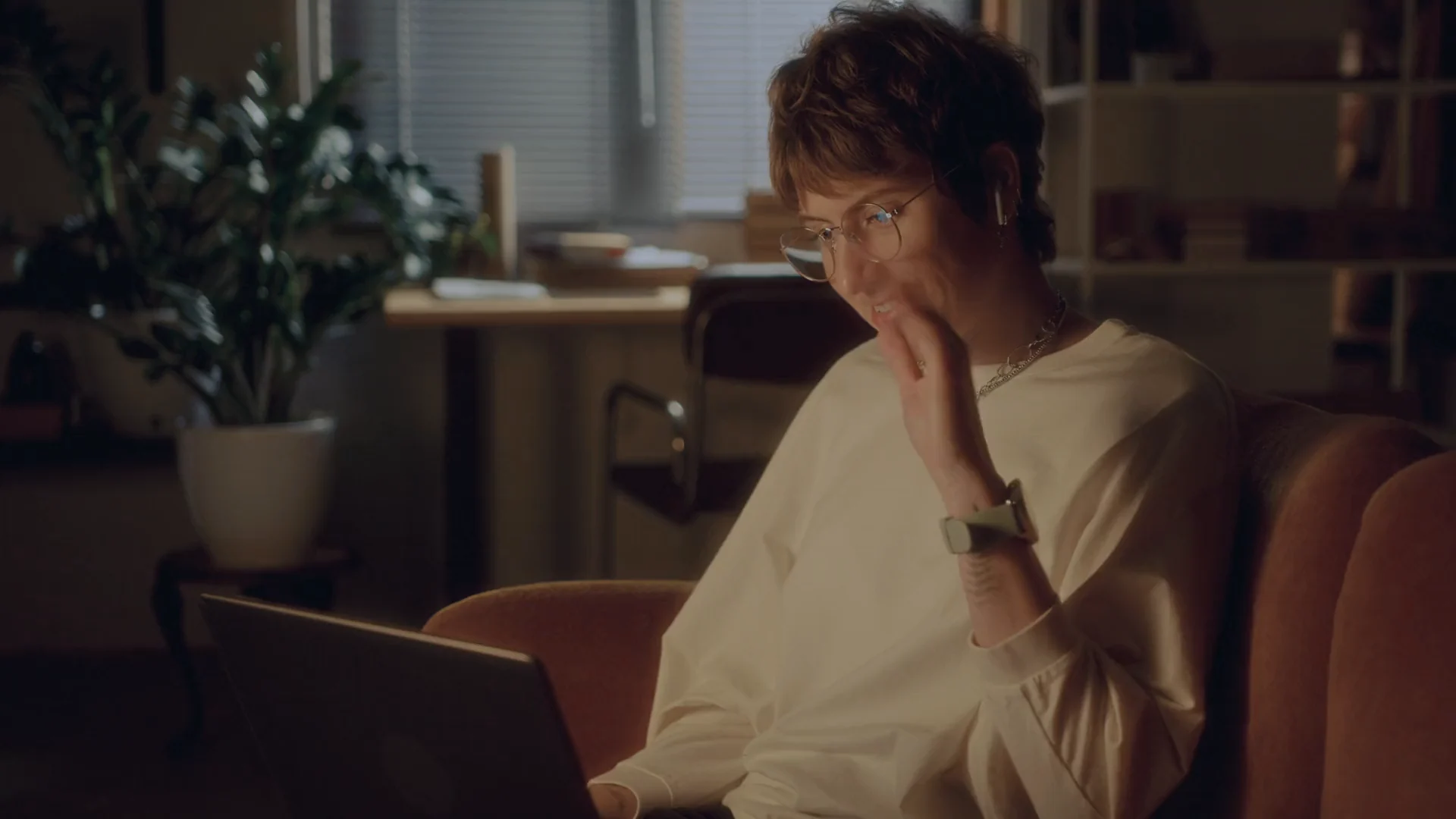 A woman talking on a video call from her laptop at home.